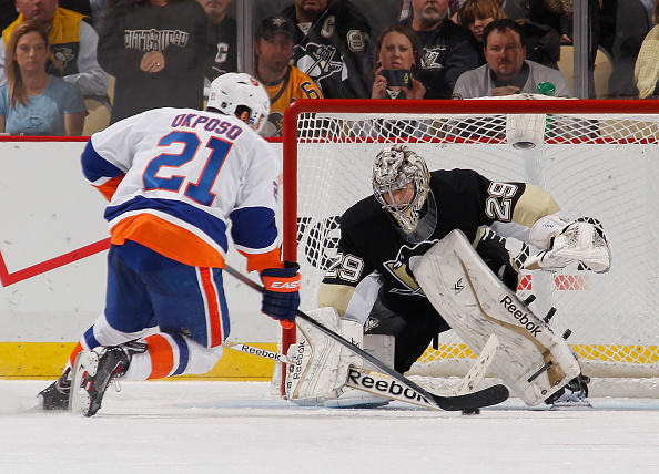 Kyle Okposo goes hard forehand to beat Marc-Andre Fleury for the winning shootout goal. -- GETTY IMAGES
